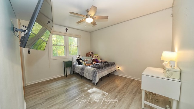 bedroom with ceiling fan and light wood-type flooring