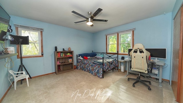 bedroom with light colored carpet and ceiling fan