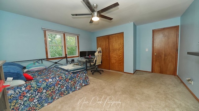 carpeted bedroom with a closet and ceiling fan