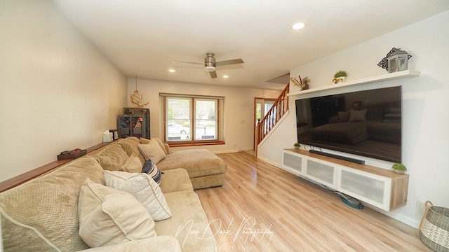 living room featuring ceiling fan and light hardwood / wood-style floors