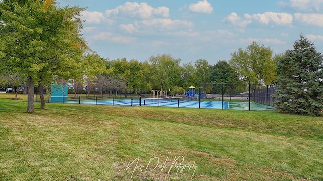 view of sport court featuring a yard