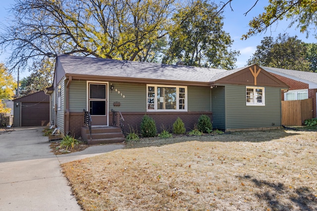 single story home featuring a garage and an outbuilding