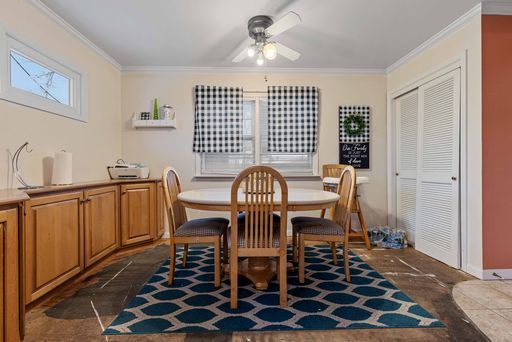 dining area featuring crown molding and ceiling fan