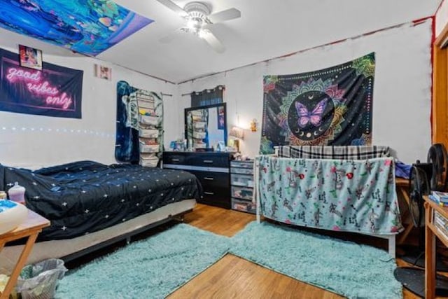 bedroom featuring wood-type flooring and ceiling fan