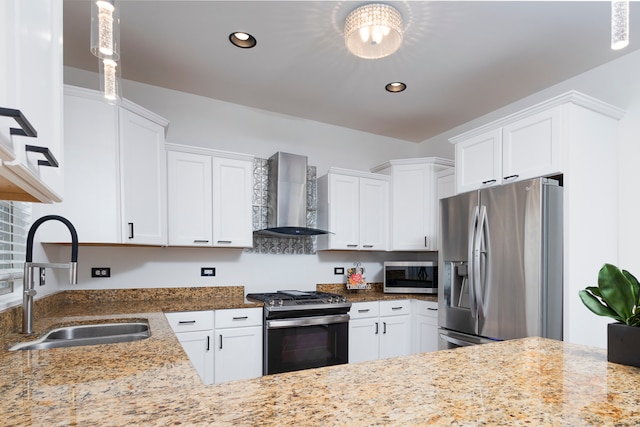 kitchen featuring sink, white cabinetry, wall chimney range hood, and stainless steel appliances