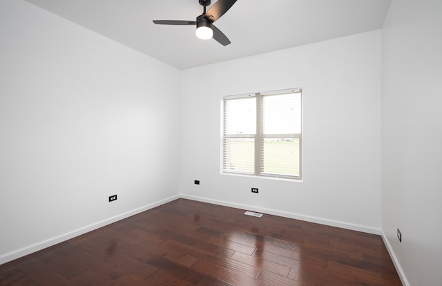 spare room with ceiling fan and dark hardwood / wood-style floors