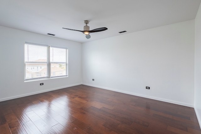 empty room featuring ceiling fan and dark hardwood / wood-style flooring