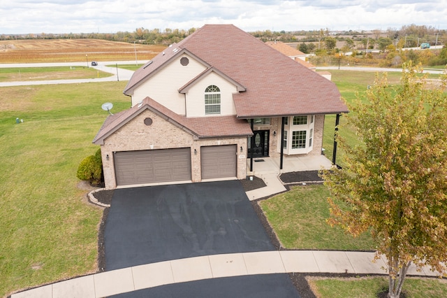 view of front of property with a front lawn and a garage