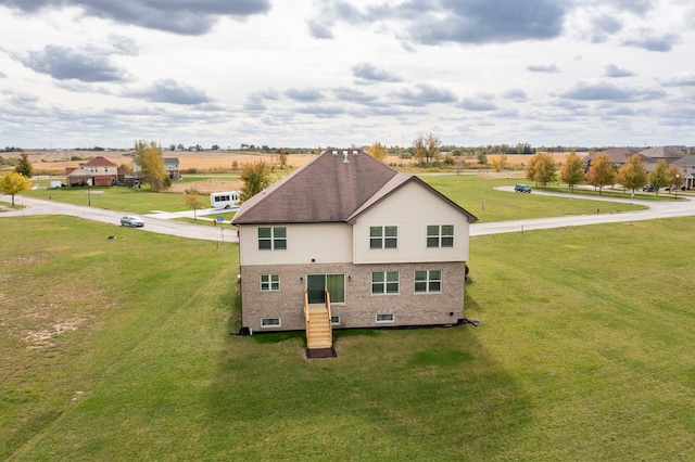 back of property featuring a yard