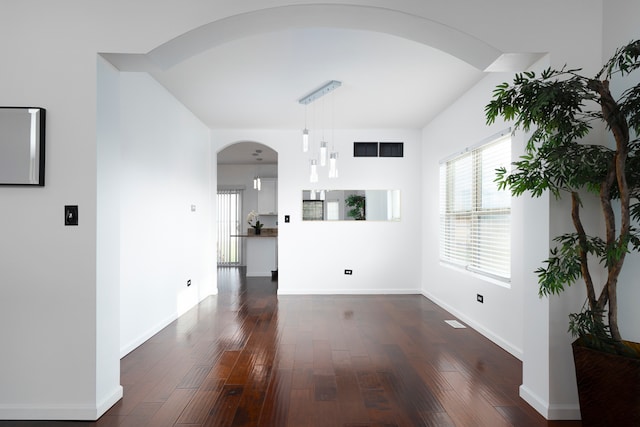 unfurnished living room with dark hardwood / wood-style floors