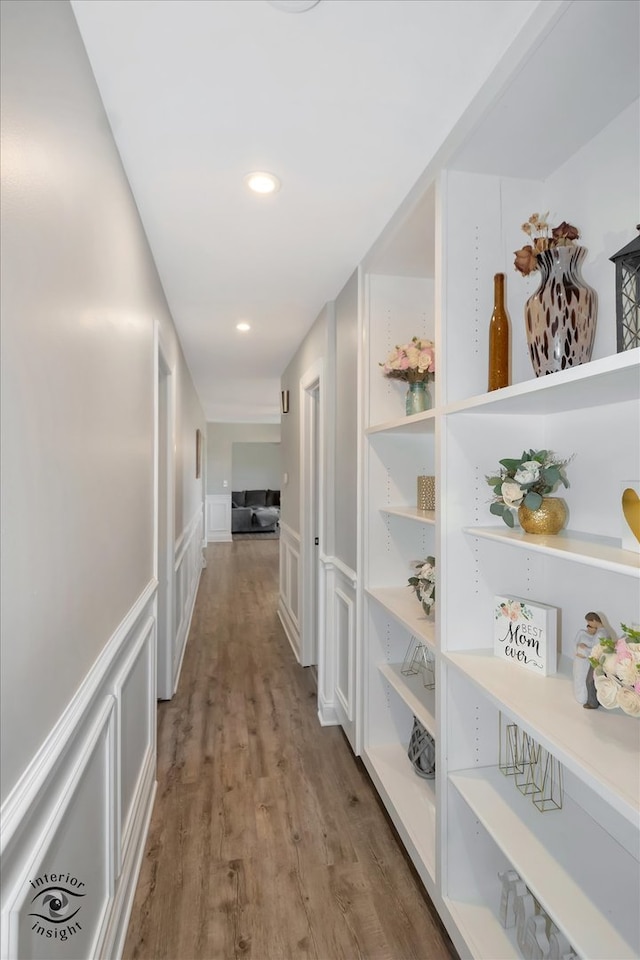 corridor with hardwood / wood-style floors