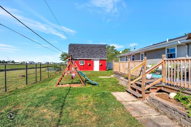 view of yard featuring a playground, a deck, and a shed