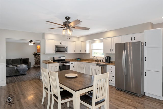 kitchen featuring ceiling fan, stainless steel appliances, sink, dark hardwood / wood-style flooring, and white cabinetry