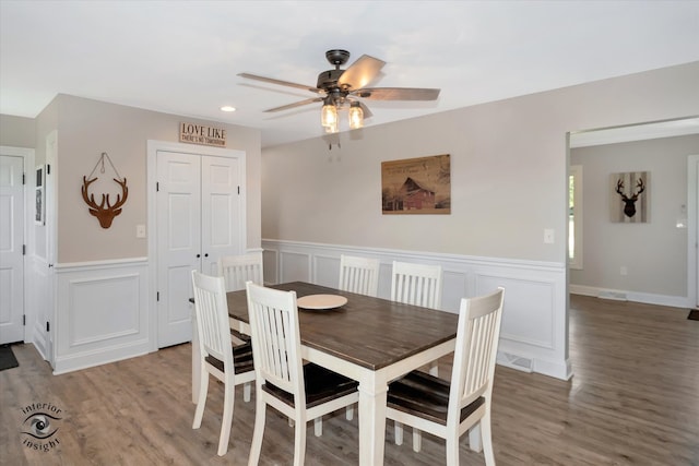 dining area with hardwood / wood-style floors and ceiling fan