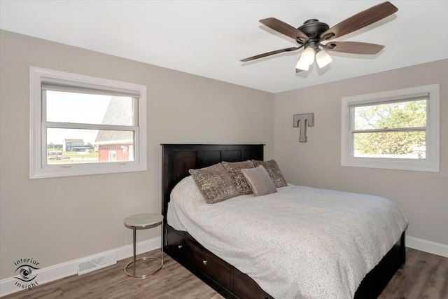 bedroom with hardwood / wood-style flooring and ceiling fan