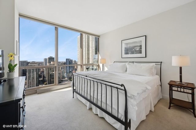 carpeted bedroom with floor to ceiling windows