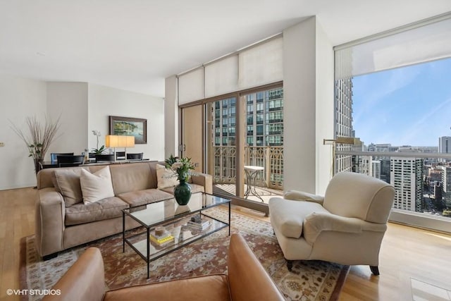 living room featuring light hardwood / wood-style flooring and floor to ceiling windows