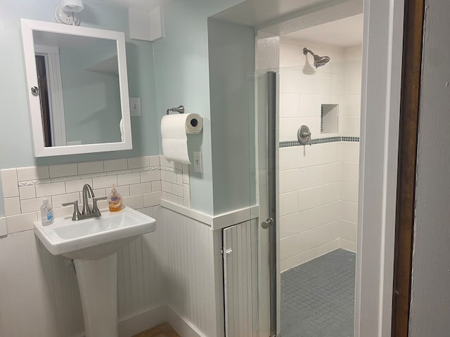 bathroom with tile walls and a tile shower