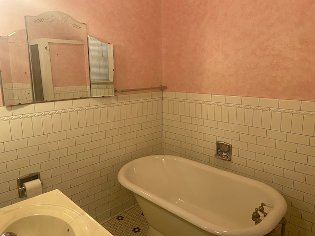 bathroom featuring a tub to relax in and tile walls