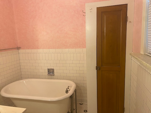 bathroom with tile walls and a bathtub