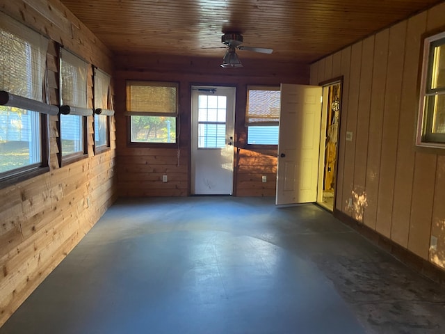 unfurnished sunroom with wood ceiling and ceiling fan