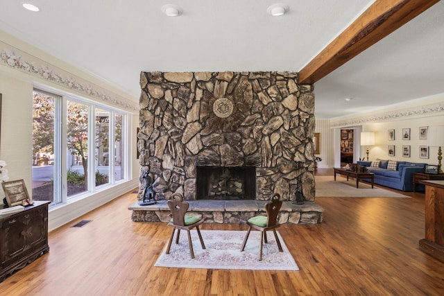 27 Hickory Ln, White Heath, IL 61884 - living room featuring beam ceiling, wood finished floors, and a fireplace