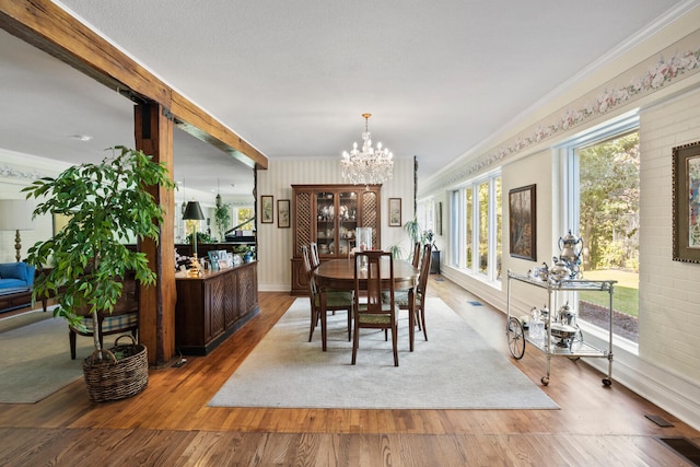 27 Hickory Ln, White Heath, IL 61884 - dining area featuring ornamental molding, a chandelier, and light wood finished floors
