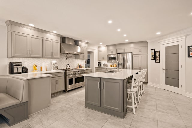 27 Hickory Ln, White Heath, IL 61884 - kitchen with wall chimney exhaust hood, stainless steel appliances, gray cabinetry, tasteful backsplash, and recessed lighting