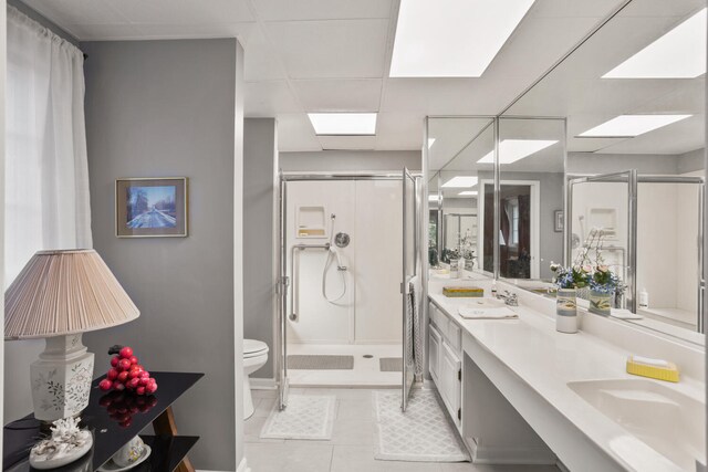 27 Hickory Ln, White Heath, IL 61884 - bathroom with a stall shower, double vanity, tile patterned flooring, and a drop ceiling