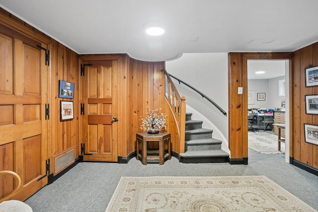 27 Hickory Ln, White Heath, IL 61884 - carpeted foyer entrance featuring stairway and wood walls