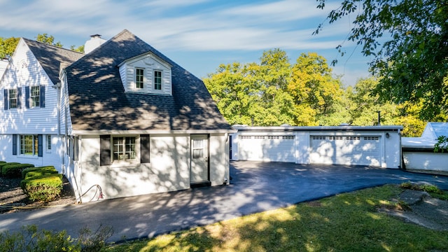 27 Hickory Ln, White Heath, IL 61884 - view of front facade featuring a garage and a chimney