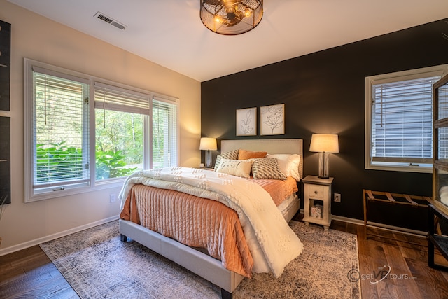 bedroom with dark wood-type flooring