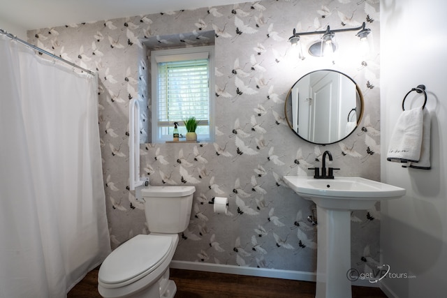 bathroom with a shower with shower curtain, toilet, and wood-type flooring