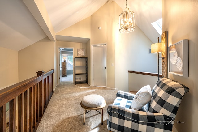 sitting room with high vaulted ceiling, a chandelier, and light colored carpet