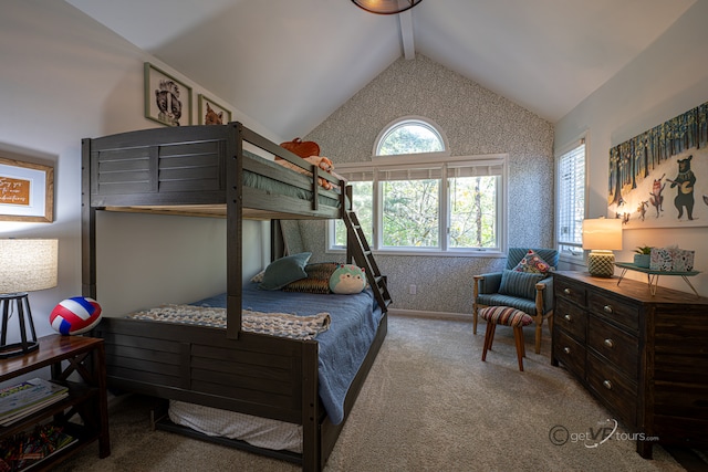 carpeted bedroom with vaulted ceiling with beams