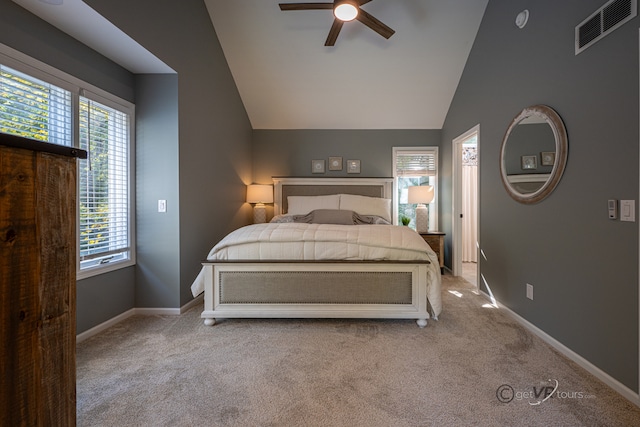 bedroom featuring light carpet, multiple windows, and ceiling fan