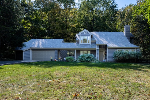 view of front of home featuring a garage and a front lawn