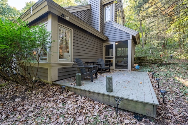 wooden deck with a sunroom