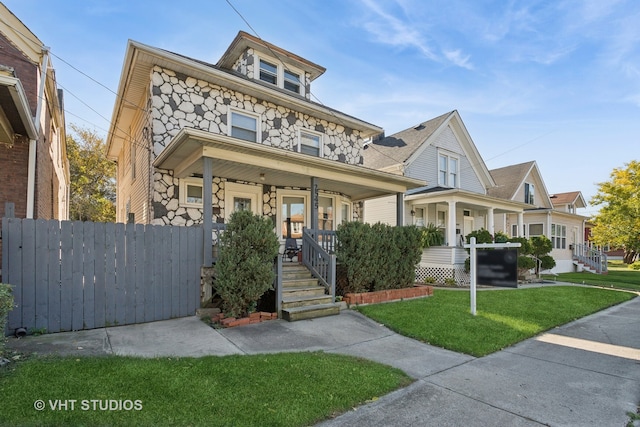 view of front of property with a porch and a front yard