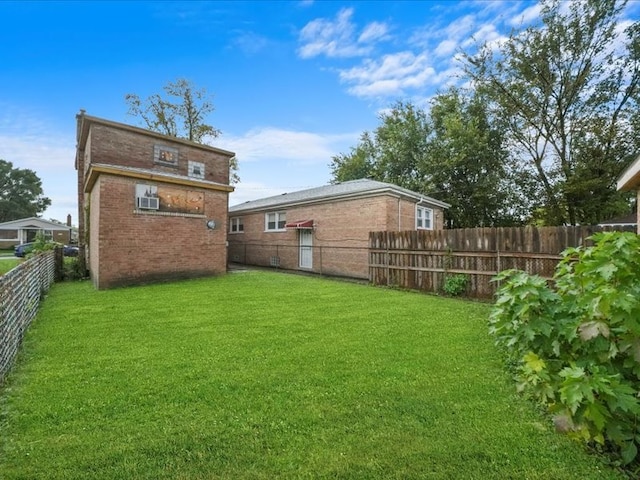 back of house featuring a lawn