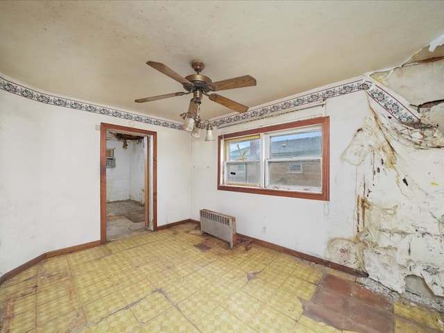 empty room featuring ceiling fan and radiator heating unit