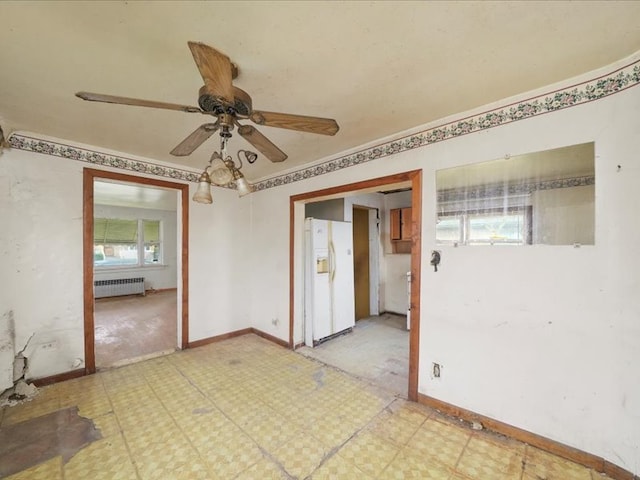 empty room featuring radiator and ceiling fan