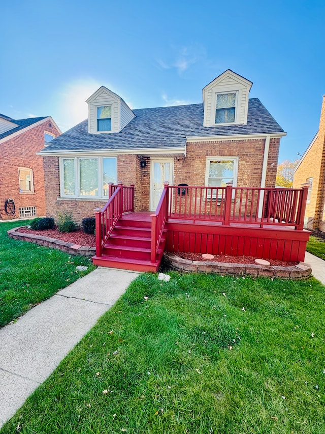 view of front of home featuring a front yard and a deck