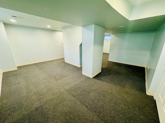 basement featuring dark carpet