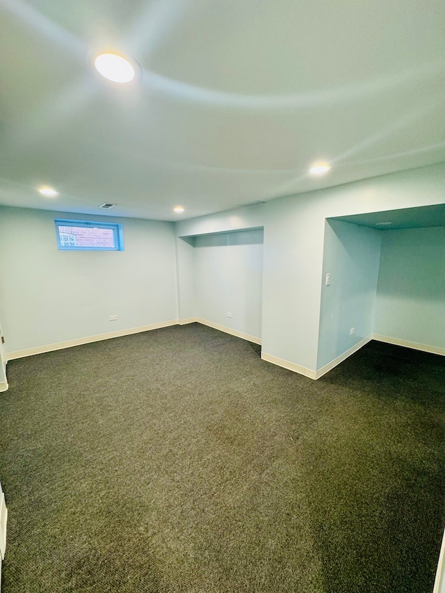 basement featuring dark colored carpet