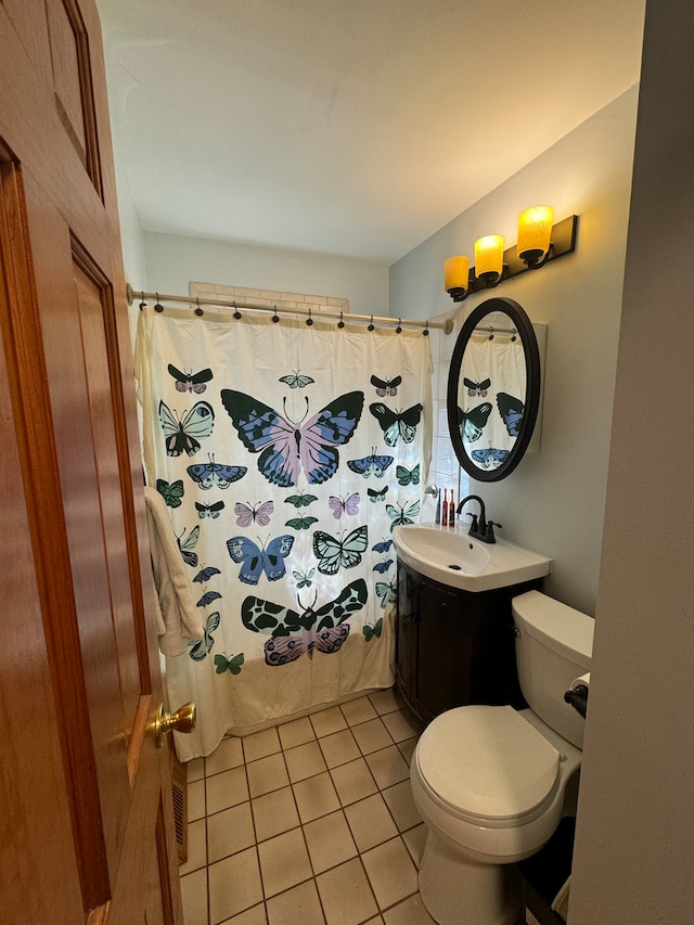 bathroom featuring tile patterned floors, a shower with shower curtain, vanity, and toilet