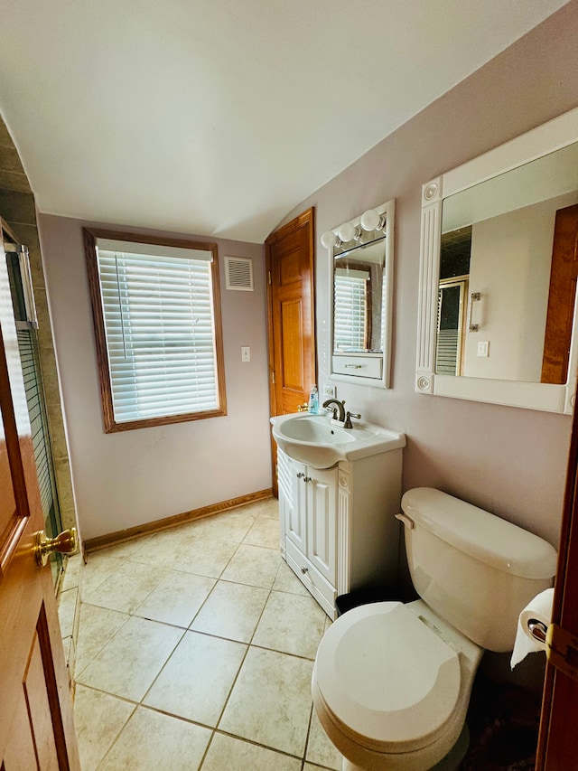 bathroom with toilet, tile patterned flooring, vanity, and a shower with shower door