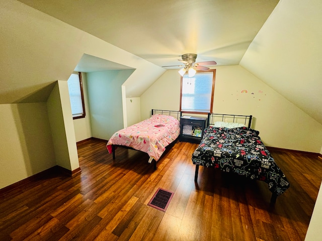 bedroom with ceiling fan, vaulted ceiling, and dark hardwood / wood-style flooring