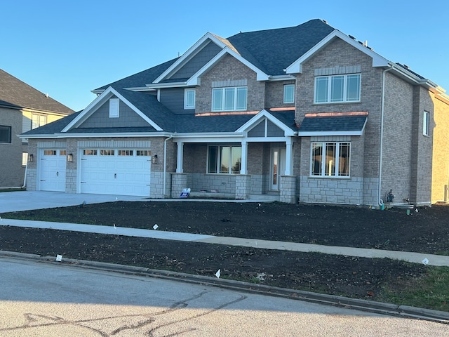 view of front of property with a garage and covered porch