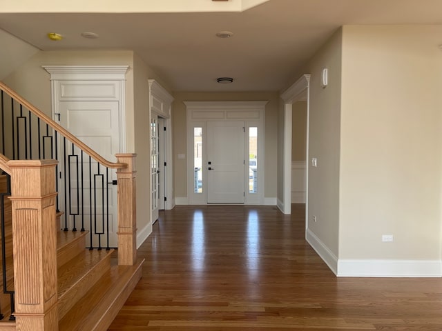 foyer entrance featuring dark wood-type flooring